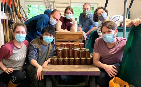 Beekeeping Society members with jars of honey honey