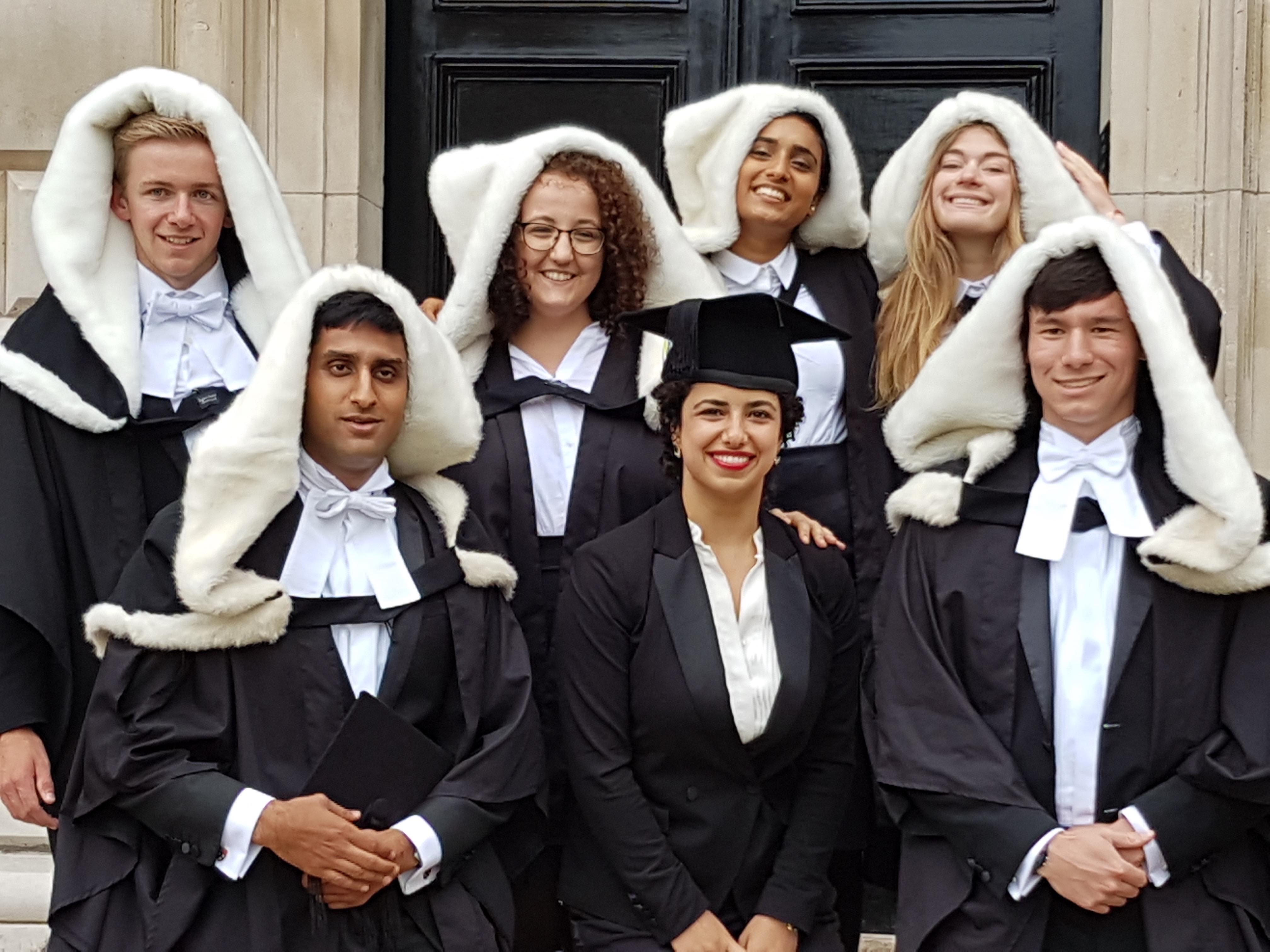 Medical students in graduation hoods medics