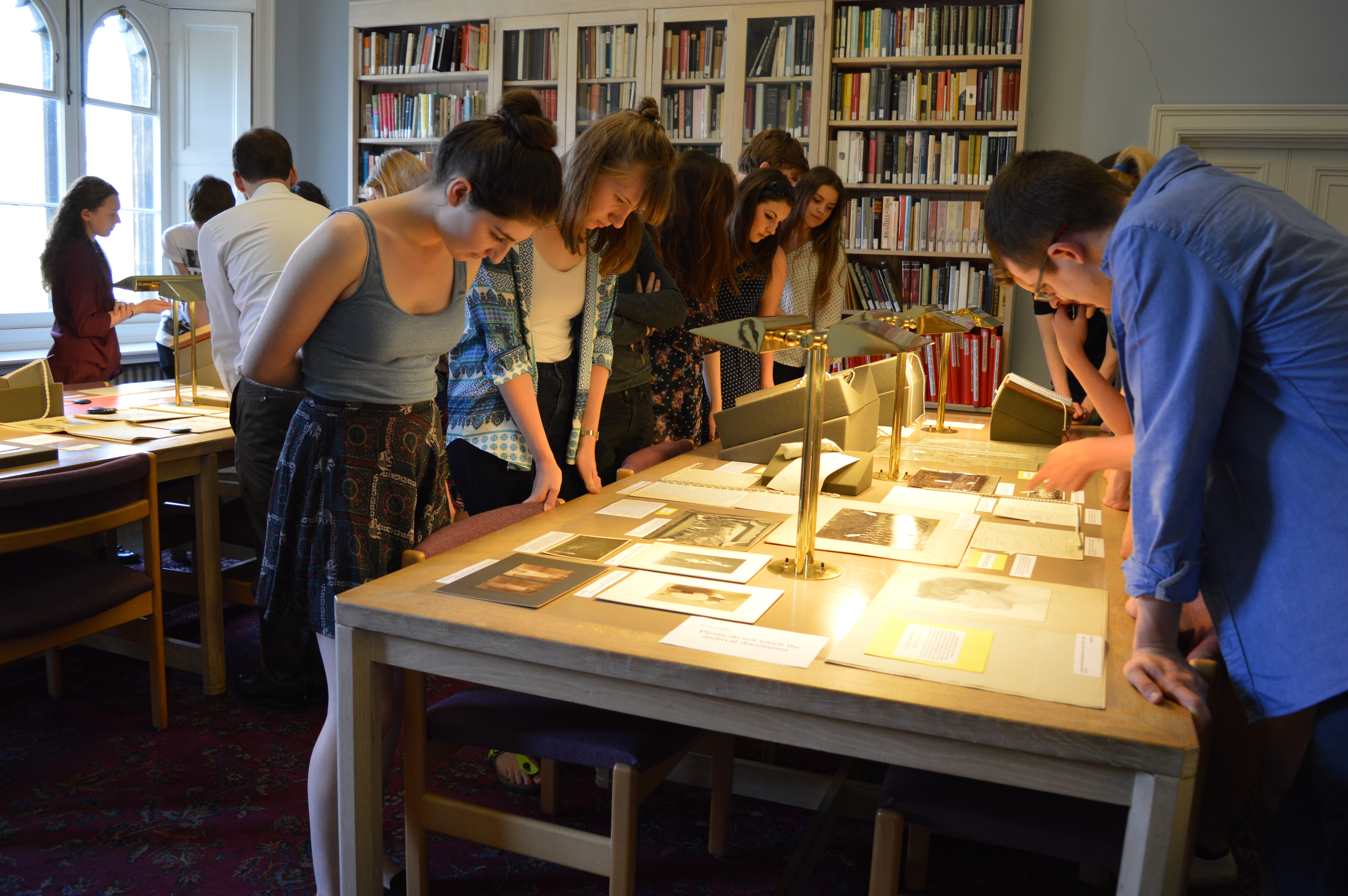 Students viewing an exhibition of Rupert Brooke papers.