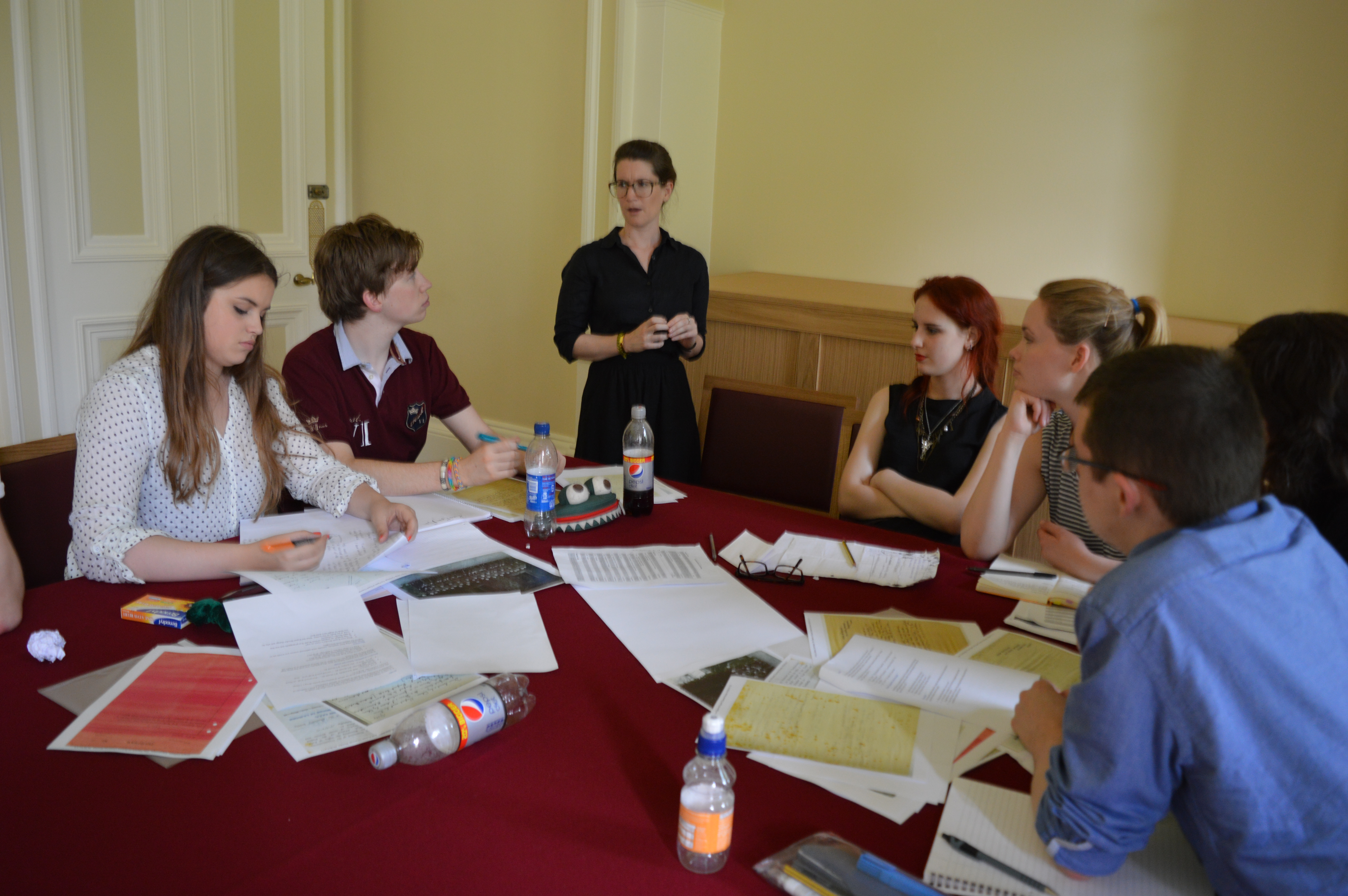 A-level students using facsimiles of archival documents during an interpretation activity, as part of a residential, and discussing them with Dr Alisa Miller (guest speaker at the event).