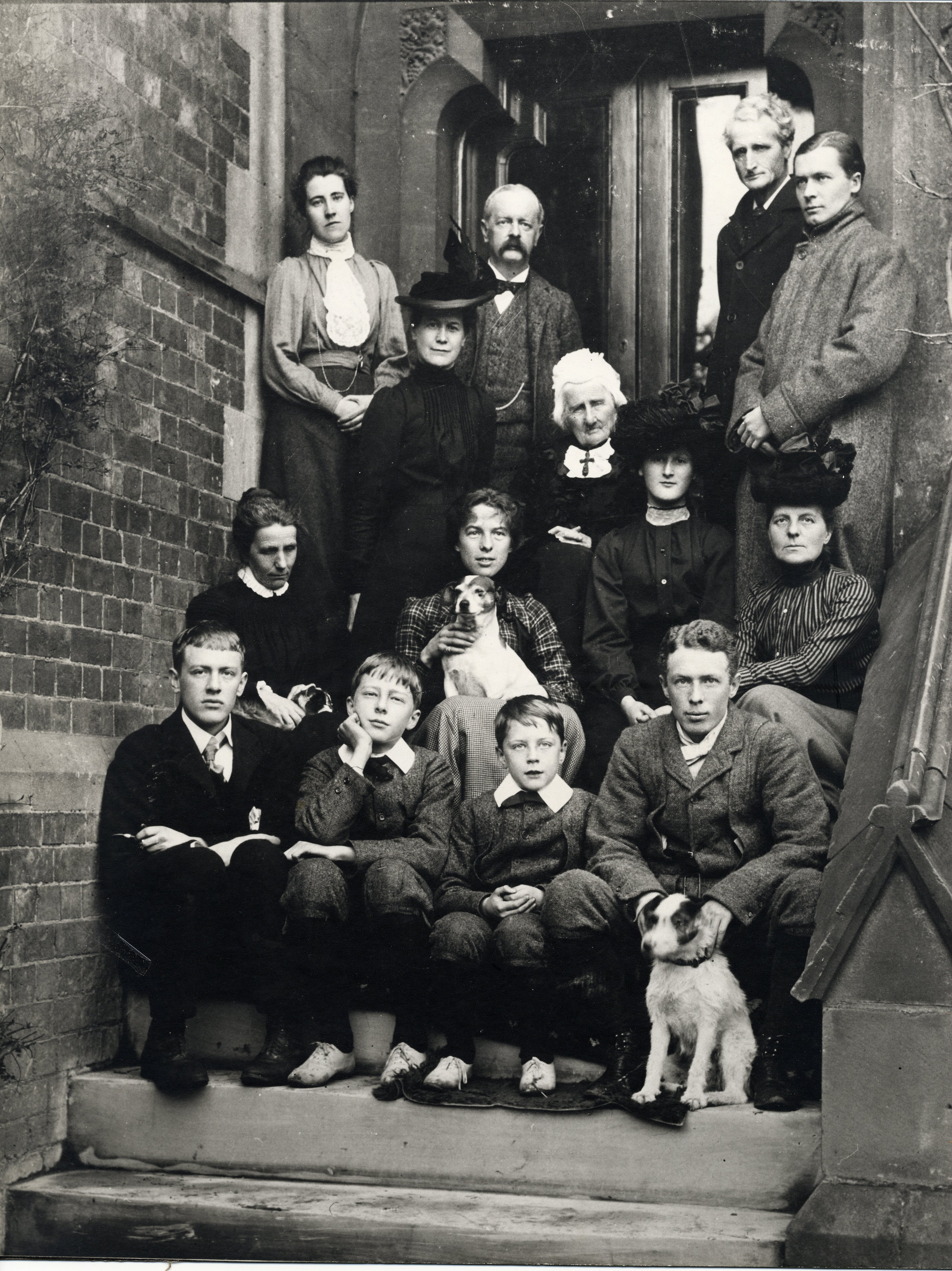 Group photograph of the Brooke and Cotterill families on steps outside house.  Rupert in the centre of the front row (RCB/Ph/9)