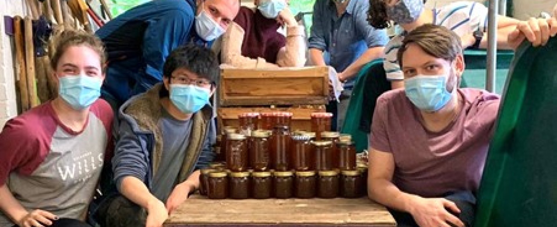 Beekeeping Society members with jars of honey honey
